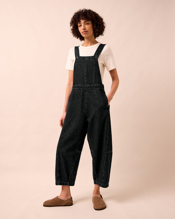 model wears gwynne washed black denim jumpsuit