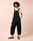 model wears gwynne washed black denim jumpsuit