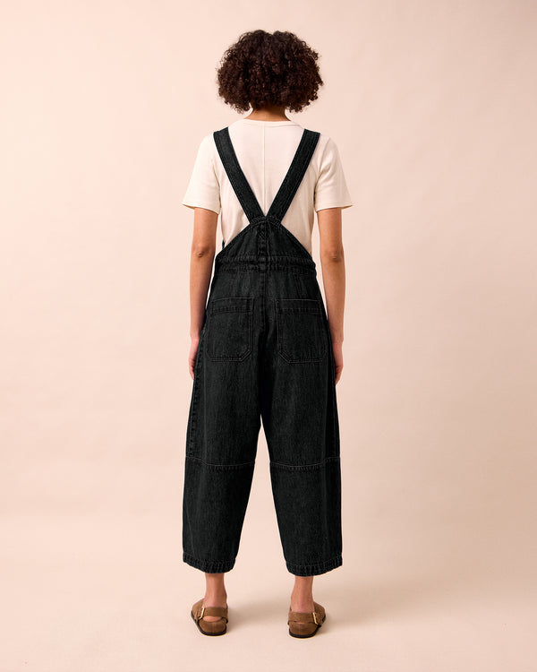 model wears gwynne washed black denim jumpsuit