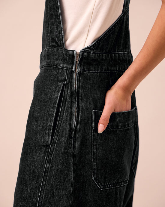 model wears gwynne washed black denim jumpsuit