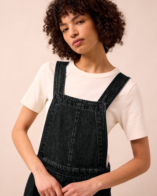 model wears gwynne washed black denim jumpsuit
