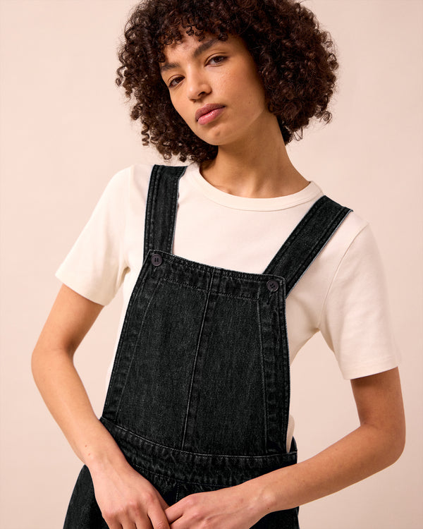 model wears gwynne washed black denim jumpsuit