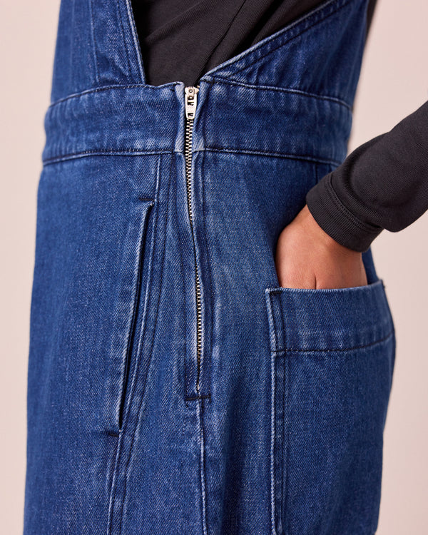 model wears gwynne mid blue denim dungerees