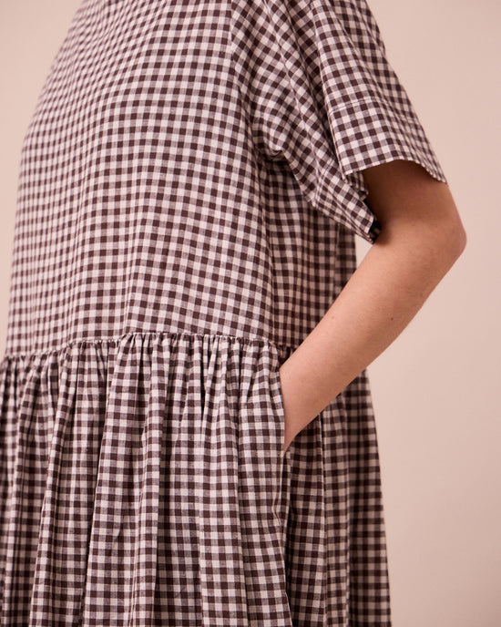 model wears harper ganache gingham cotton linen dress