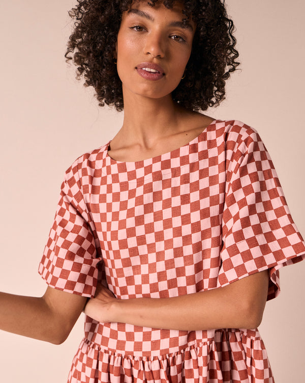 model wears harper rosewood checkerboard linen dress