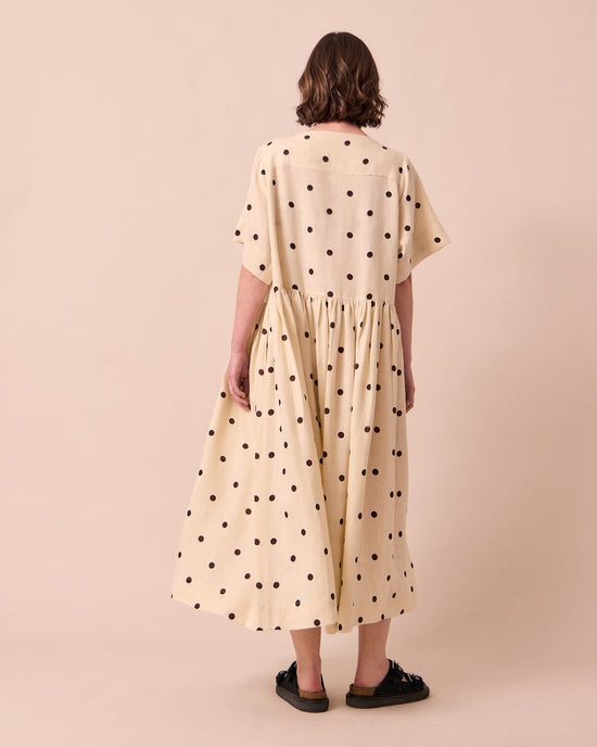 model wears harper bone spot linen dress