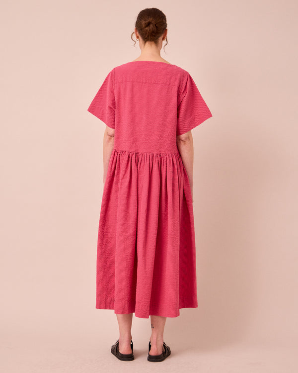 model wears harper raspberry stripe seersucker dress