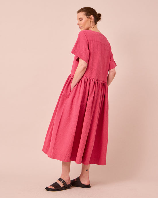 model wears harper raspberry stripe seersucker dress