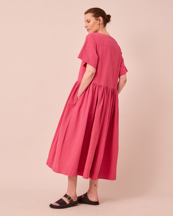 model wears harper raspberry stripe seersucker dress