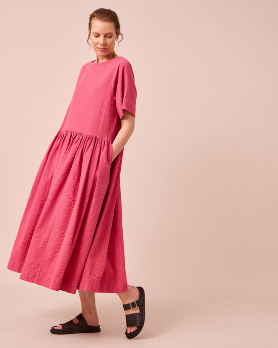 model wears harper raspberry stripe seersucker dress