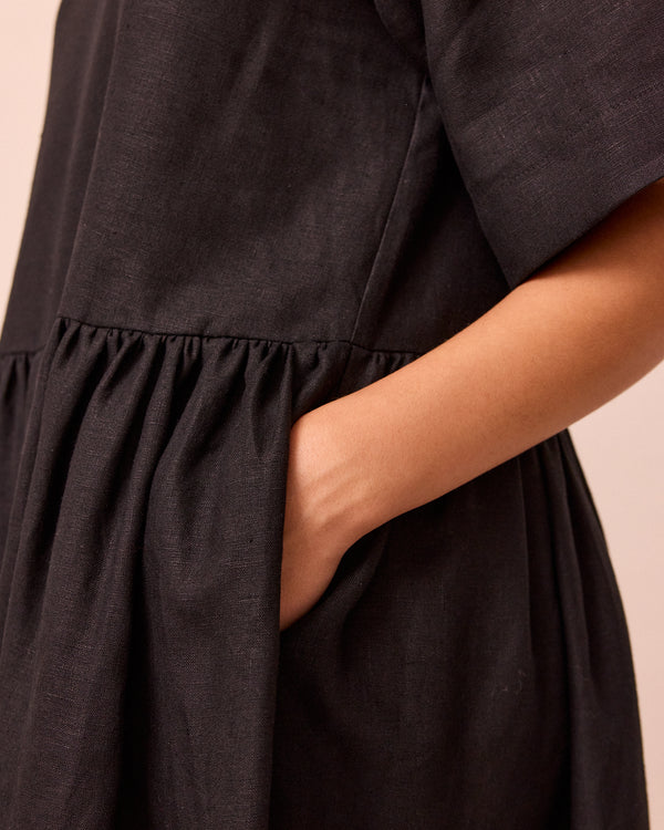 model wears harper black linen dress