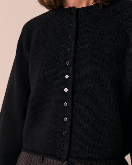 model wears henna black knitted cardigan