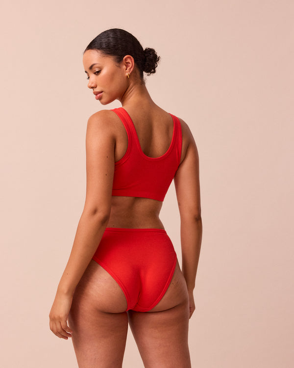 model wears tomato red jersey bralette