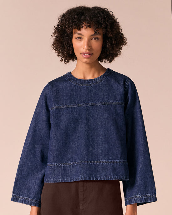 model wears hunter dark wash denim top