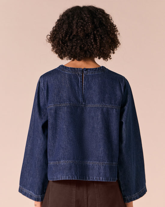model wears hunter dark wash denim top