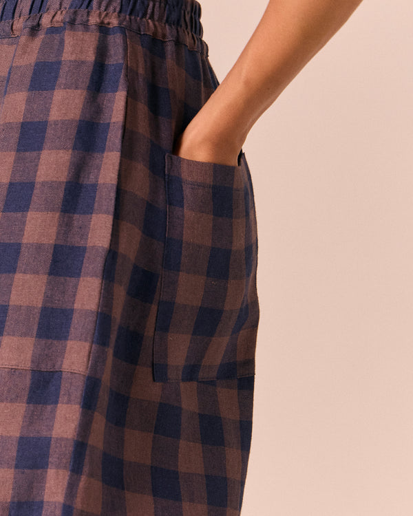 model wears huxley cedar check linen trousers