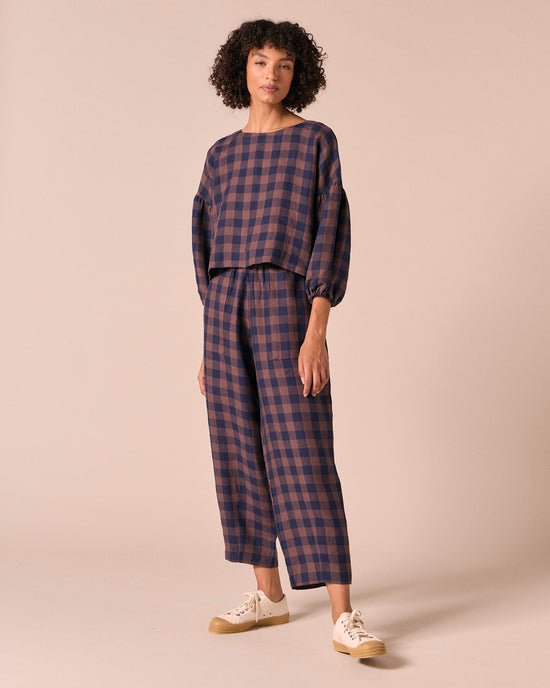 model wears huxley cedar check linen trousers right