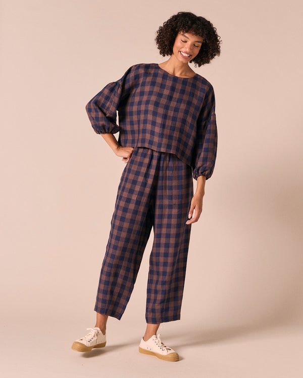 model wears huxley cedar check linen trousers left