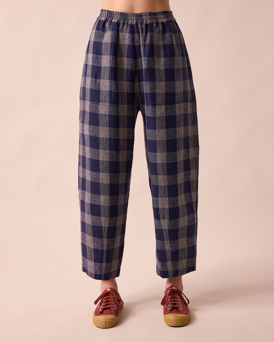 model wears huxley navy plaid linen trousers front
