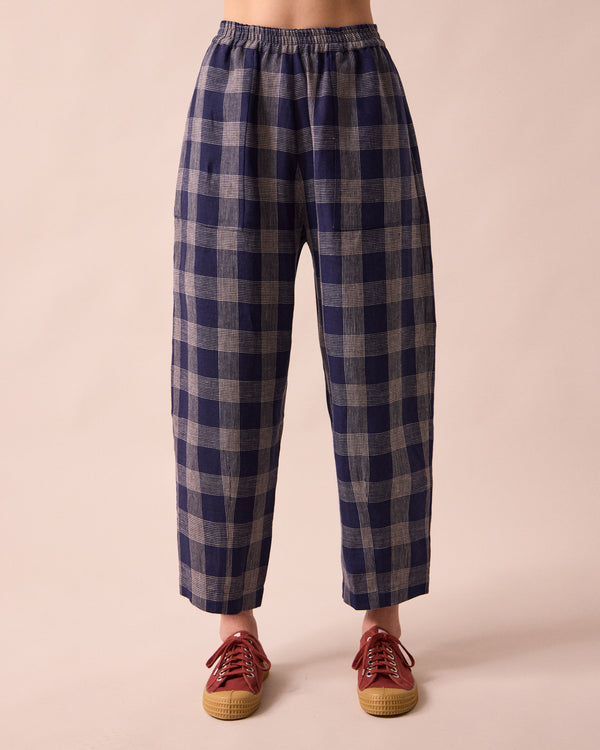 model wears huxley navy plaid linen trousers front