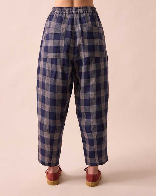 model wears huxley navy plaid linen trousers back