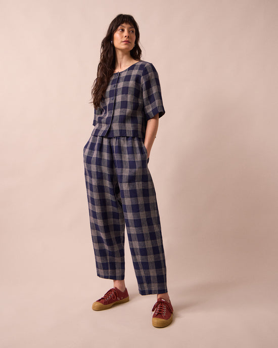model wears huxley navy plaid linen trousers right