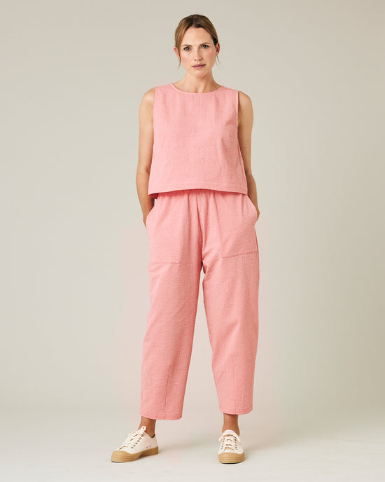 model wears coral seersucker huxley trousers