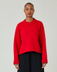 model wears flame red coco jumper 