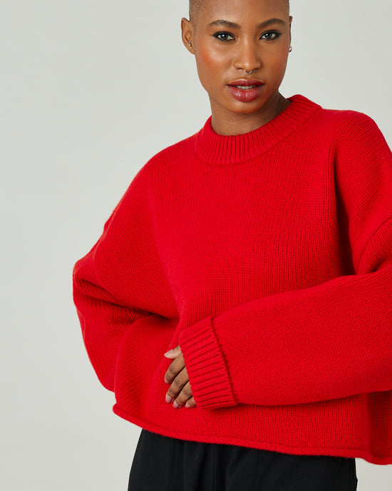 model wears flame red coco jumper 