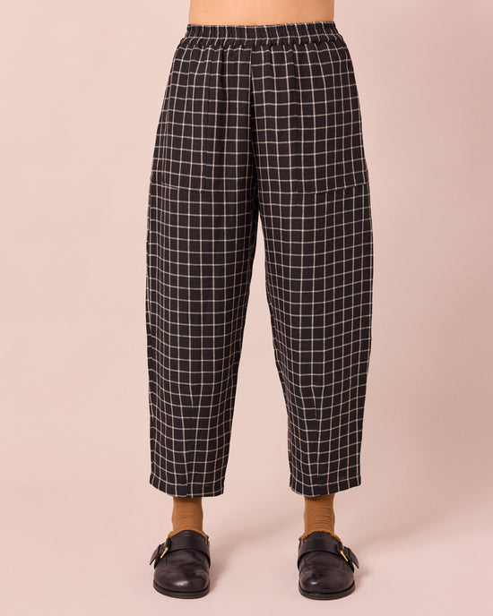 model wears huxley black grid linen trousers front