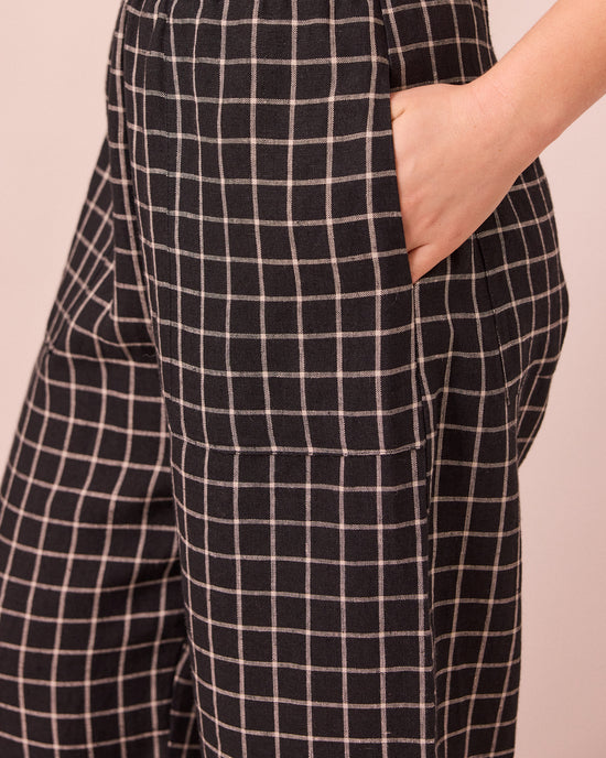 model wears huxley black grid linen trousers