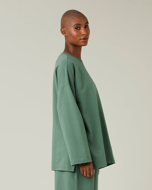 model wears dusty green huxley top