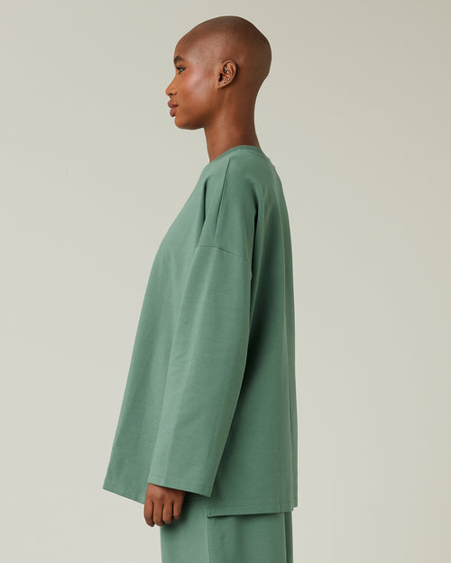 model wears dusty green huxley top