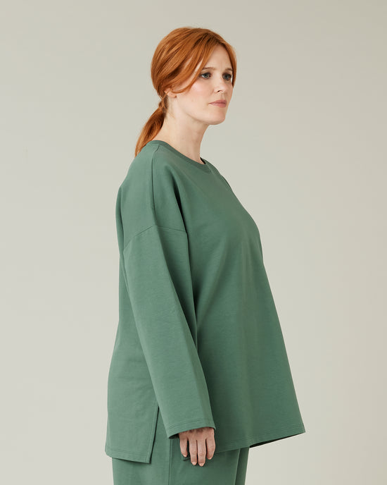 pregnant model wears dusty green huxley top