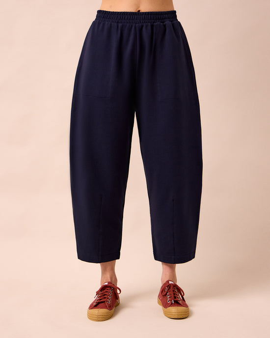 model wears huxley ink jersey trousers front