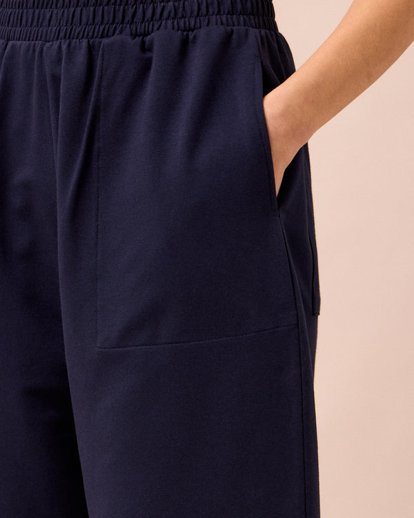 model wears huxley ink jersey trousers 