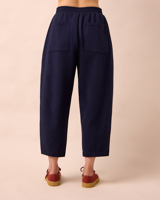 model wears huxley ink jersey trousers back