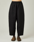 model wears black linen huxley trousers front