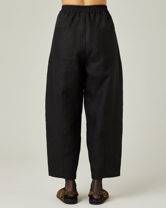 model wears black linen huxley trousers back