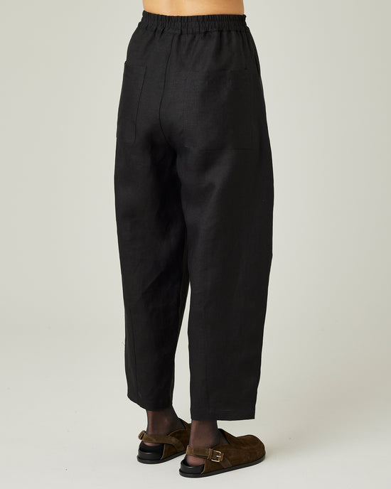 model wears black linen huxley trousers right