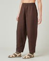 model wears brown huxley linen trousers front