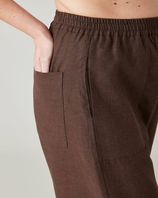 pregnant model wears brown huxley linen trousers