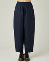 model wears navy huxley linen trousers front