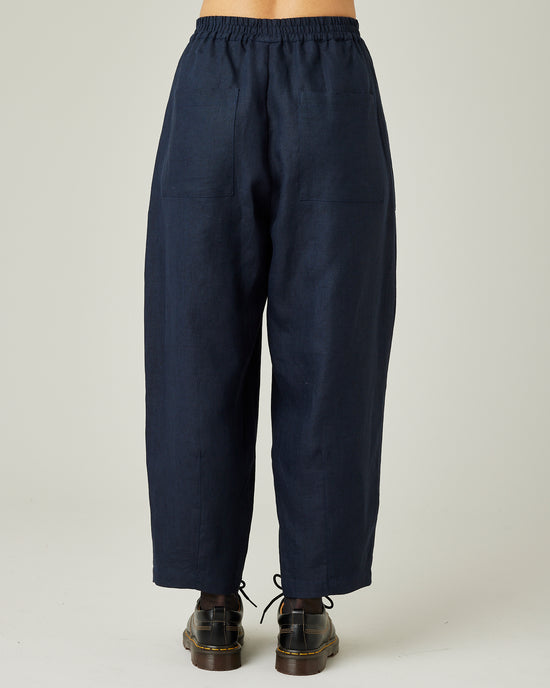 model wears navy huxley linen trousers back