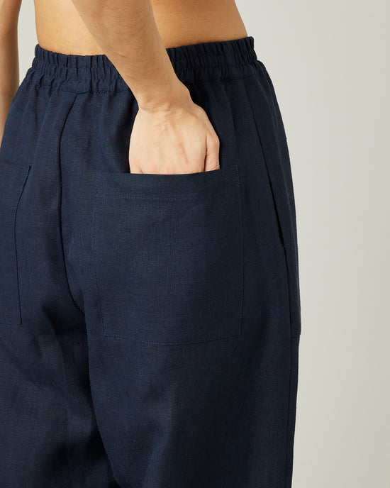 model wears navy huxley linen trousers 