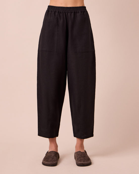 model wears huxley black linen trousers front