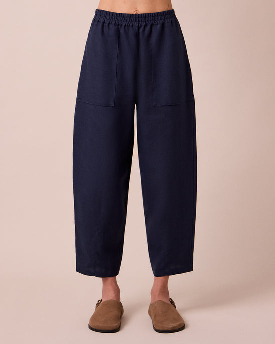 model wears huxley navy linen trousers front