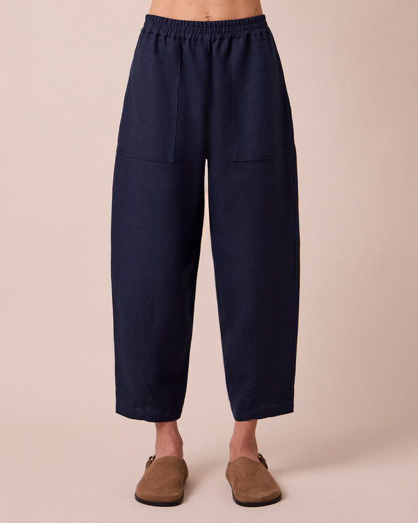 model wears huxley navy linen trousers front