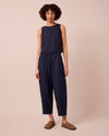 model wears huxley navy linen trousers left
