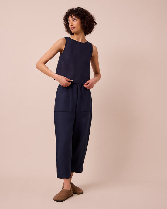 model wears huxley navy linen trousers right